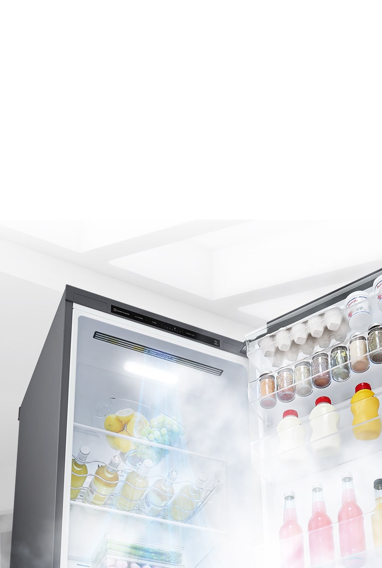 The refrigerator is shown open at an angle and filled with produce. White air is blowing from the top of the interior down around all of the food to keep it cool.