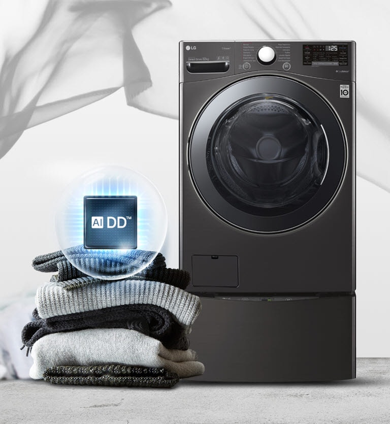 A black washer sits facing front with a stack of sweaters and blankets to the left and the AIDD logo with a light blue circle around it on top.