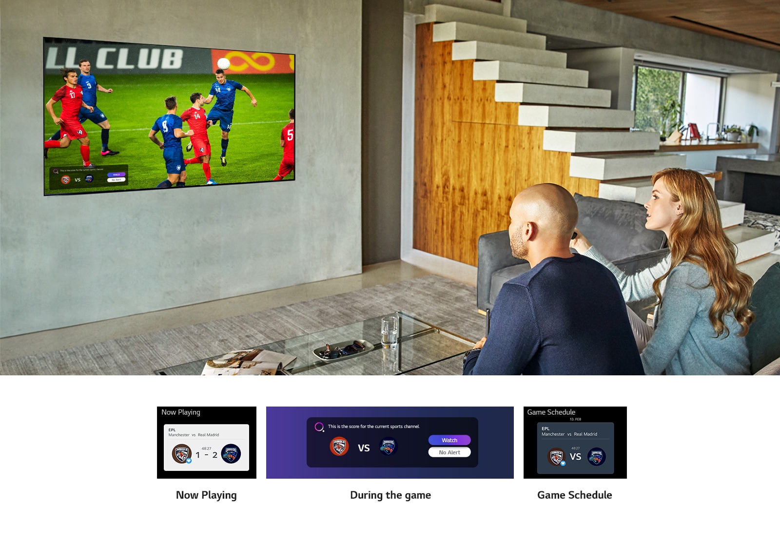 A man and woman sat behind a coffee table in front of a wall mounted TV showing a football match.