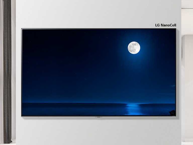 Scrollable image of a wall mounted TV showing a dark scene of a full moon reflecting on water. The scene alternates between a regular size TV and large screen LG NanoCell TV.